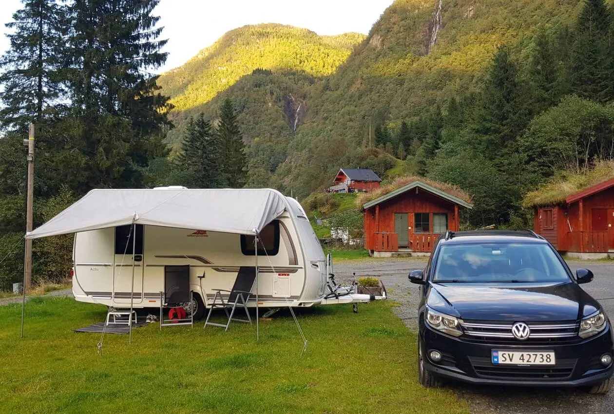 Campingvogn med fortelt på enga